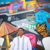 Ever Rodriguez in front of a mural on Middlefield Road in North Fair Oaks on May 10, 2021. The mural was made by artist Jose Castro. (Beth LaBerge/KQED)