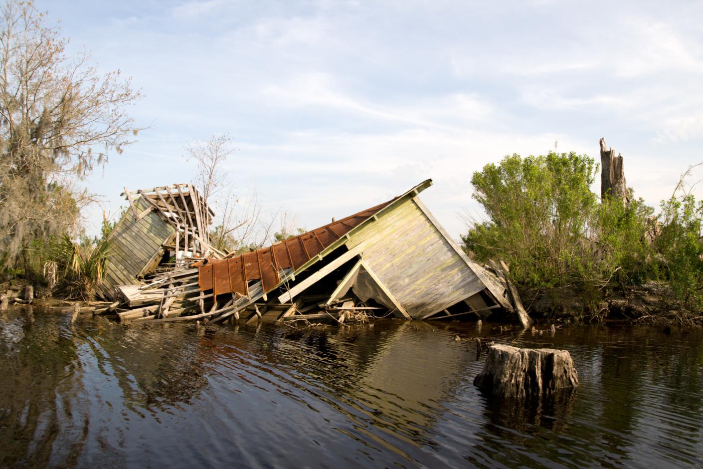 A coastal house is ruined after a natural disaster