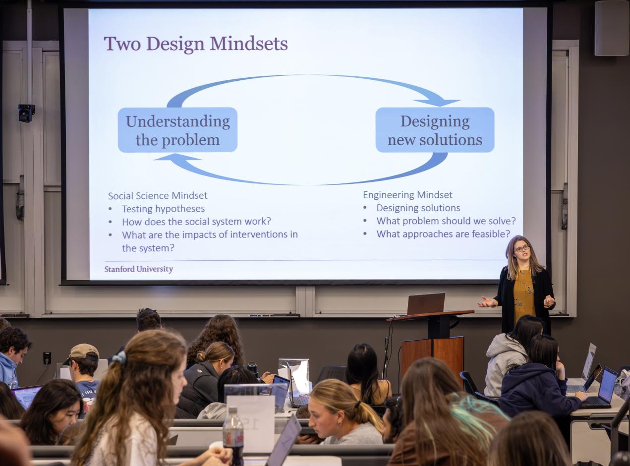 Image of female teacher giving a presentation to a class