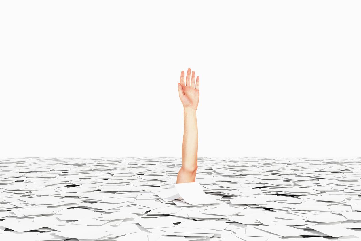 arm drowning in a sea of papers