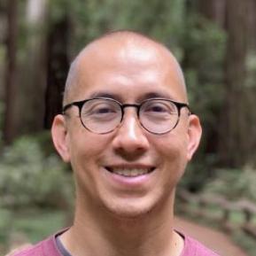 Image of male with glasses wearing a read t-shirt.