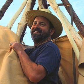 image of male wearing a hat and a blue shirt