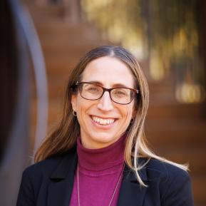 image of female wearing a maroon top and black blazer