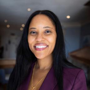 image of female wearing a burgundy suit with black hair