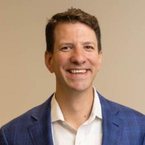 image of male wearing a blue suit and white shirt with brown hair