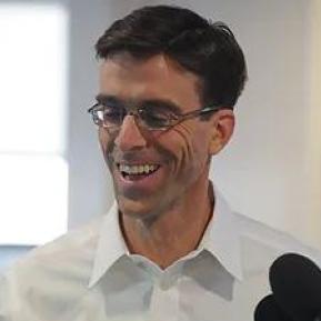 image of male with glasses wearing a white shirt 