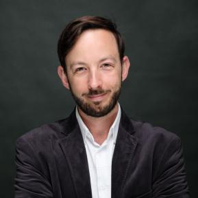 image of male wearing a black suit and white shirt