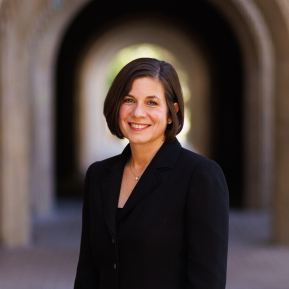 image of female wearing a black suit with short black hair