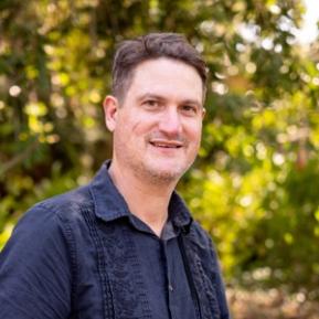 image of male with brown hair wearing a blue shirt