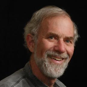 Image of male with grey hair wearing a green shirt