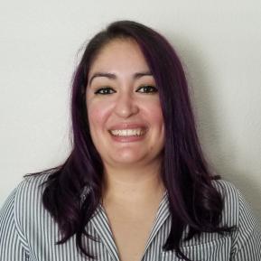 Image of female with purple hair wearing a striped shirt