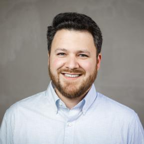 Image of male with a beard wearing a blue shirt