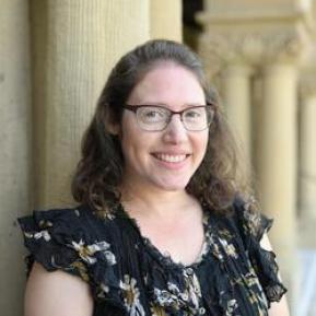 Image of female white brown hair and glasses wearing a black top