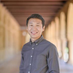 Image of Asian male with black hair wearing a grey shirt