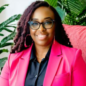 image of female with black glasses wearing a black shirt and pink jacket