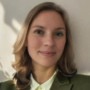 Image of blonde female wearing a green blazer and white shirt