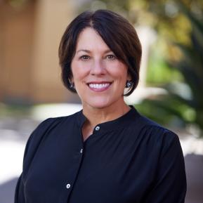 headshot of female with brown hair wearing a black shirt