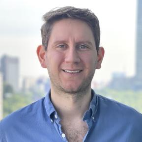 person wearing a blue shirt with blonde hair