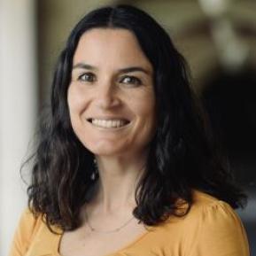 female with black hair wearing a yellow top