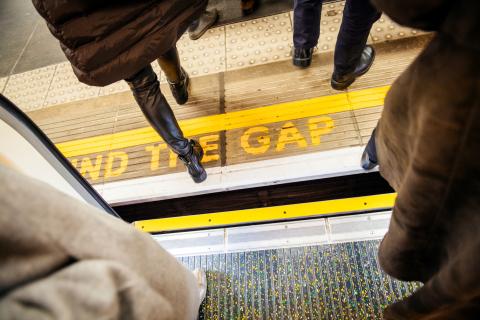 Subway platform with "Mind the gap" warning