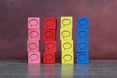 Stacks of colorful blocks with the message-bubble icon