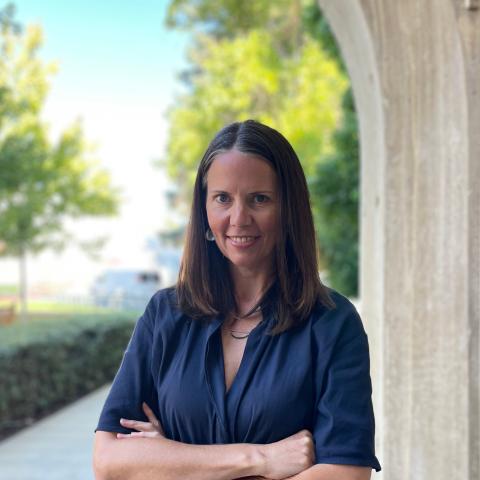 image of female with brown hair wearing a blue shirt