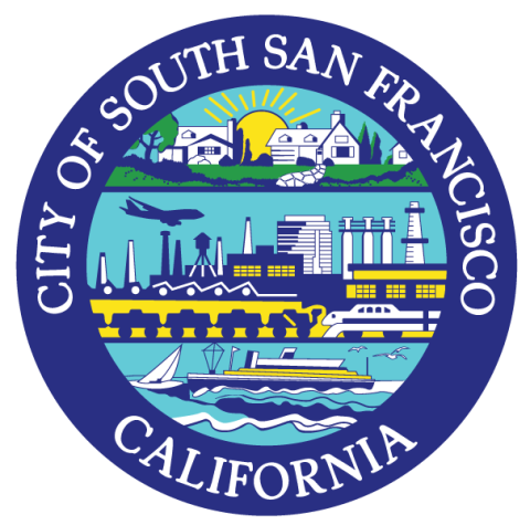 The image shows the seal of the City of South San Francisco, California. It features a circular design divided into sections: a sunrise over homes at the top, industrial elements like factories and an airplane in the middle, and a boat on water at the bottom. The text "CITY OF SOUTH SAN FRANCISCO" arcs around the top, and "CALIFORNIA" is at the bottom, both in white against a blue background. The seal highlights the city’s community, industry, and coastal character.