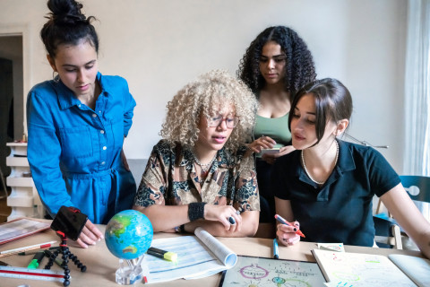 Four young women preparing a climate action project