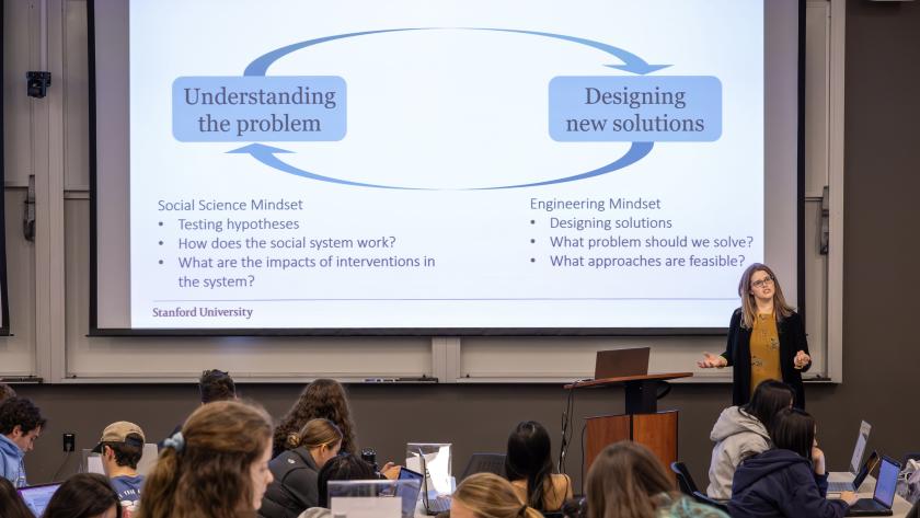 Image of female teacher giving a presentation to a class