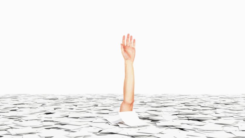 arm drowning in a sea of papers