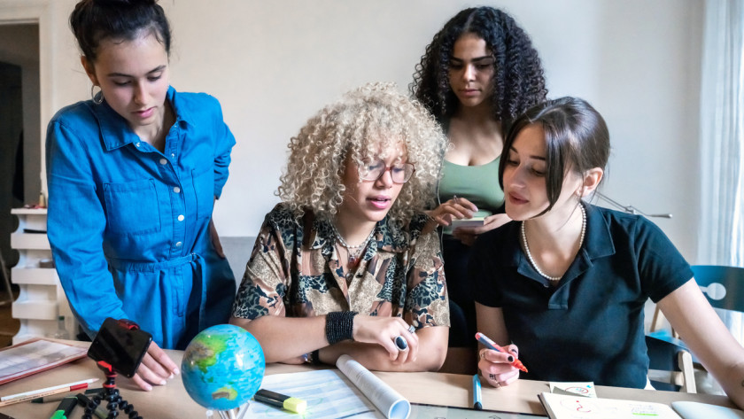 Four young women preparing a climate action project