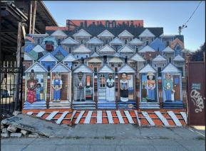 A mural in Oakland depicting residents and housing