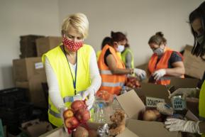 Workers at a food bank sorting items