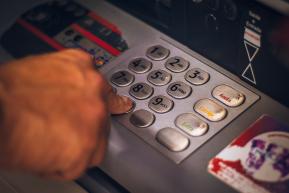 A person entering their ATM PIN