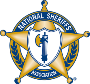 The image shows the logo of the National Sheriffs' Association. It features a gold sheriff's star, with a central emblem that includes a blue and white shield. The text "NATIONAL SHERIFFS' ASSOCIATION" curves along the top of the star, and there are decorative elements, including laurel branches, surrounding the star.