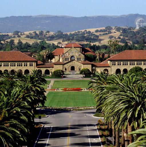 View of Stanford's Palm Drive with view of Main Quad, Memorial Church, and hills in the distance