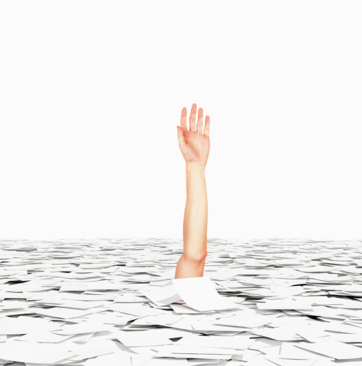 arm drowning in a sea of papers