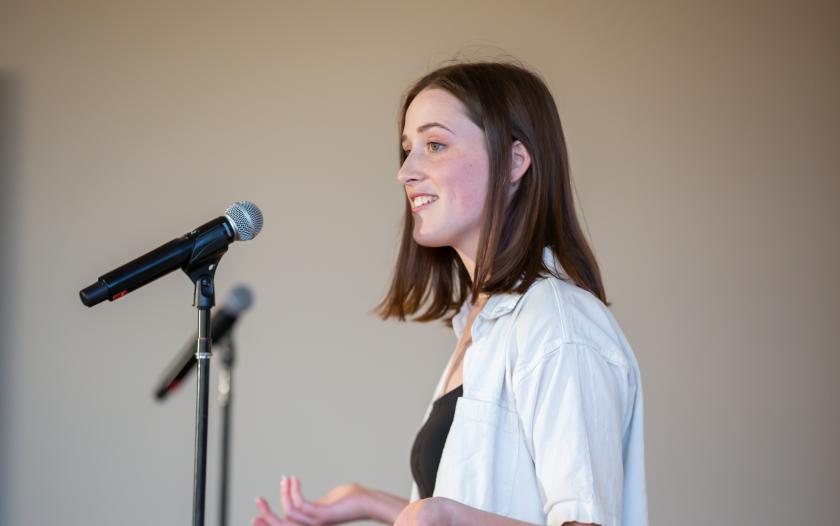 Female standing at mic