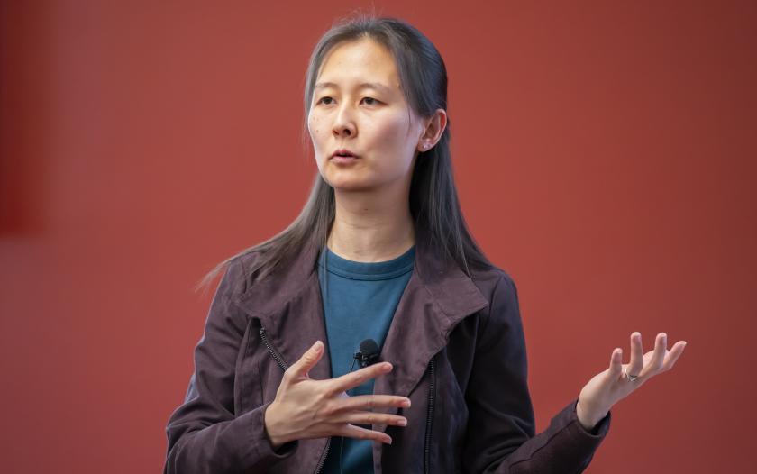 woman wearing a maroon jacket and blue shirt