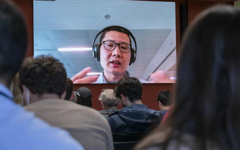 MAn on a screen wearing headphones