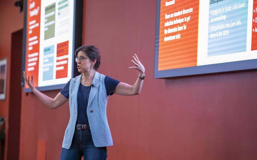 Person standing in front of a screen wearing a half sleeved coat