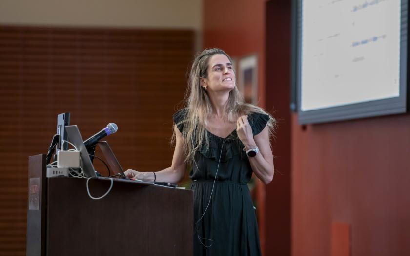 person wearing a black dress standing at a podium